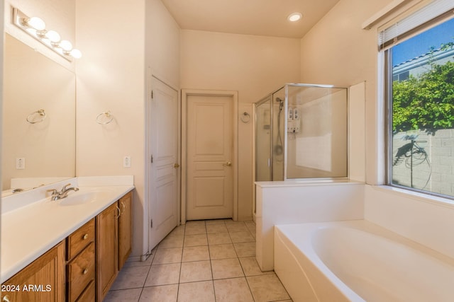 bathroom with vanity, tile patterned flooring, and plus walk in shower