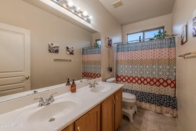 bathroom with tile patterned floors, a shower with curtain, vanity, and toilet