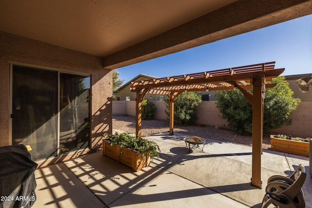 view of patio featuring a pergola and an outdoor fire pit