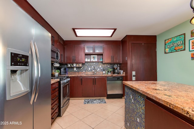 1326 W Joan De Arc Ave, Phoenix, AZ 85029 - kitchen featuring appliances with stainless steel finishes, backsplash, light tile patterned flooring, and light countertops