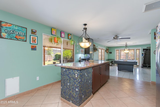 1326 W Joan De Arc Ave, Phoenix, AZ 85029 - kitchen with a kitchen island, light tile patterned floors, a ceiling fan, and decorative light fixtures