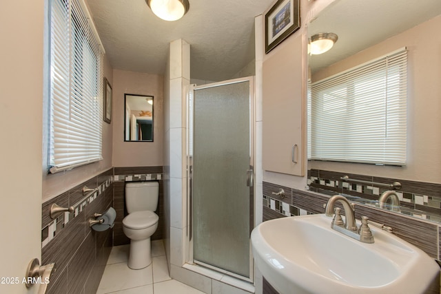 1326 W Joan De Arc Ave, Phoenix, AZ 85029 - full bath with tile walls, a shower stall, tile patterned flooring, and wainscoting