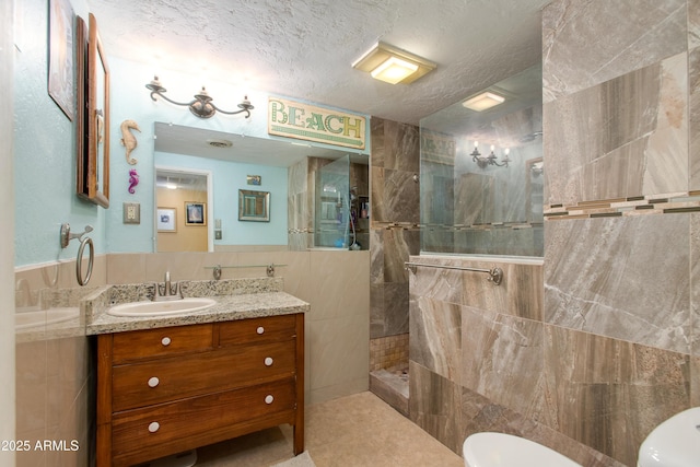 1326 W Joan De Arc Ave, Phoenix, AZ 85029 - full bathroom with vanity, a walk in shower, a textured ceiling, tile walls, and tile patterned floors