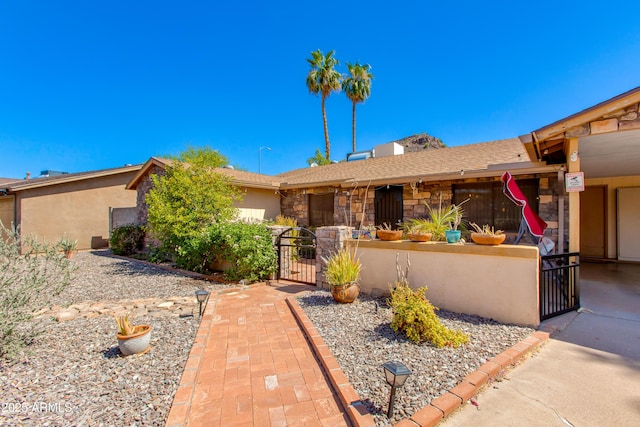 1326 W Joan De Arc Ave, Phoenix, AZ 85029 - single story home featuring a gate, stone siding, and a fenced front yard