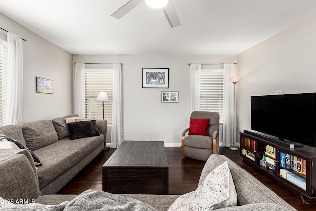 living room featuring dark wood finished floors, baseboards, and ceiling fan