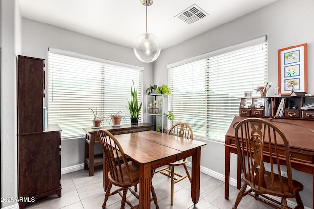 dining area with a healthy amount of sunlight, visible vents, and baseboards