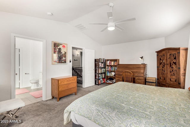 bedroom with visible vents, ceiling fan, lofted ceiling, carpet floors, and ensuite bath