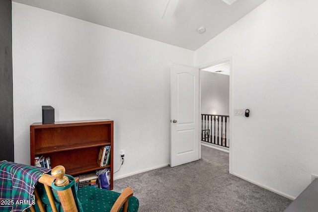 living area featuring baseboards, carpet floors, and vaulted ceiling