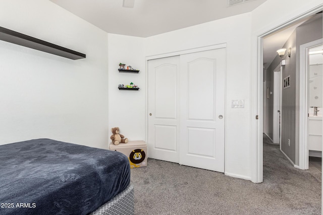 bedroom featuring visible vents, carpet, and a closet