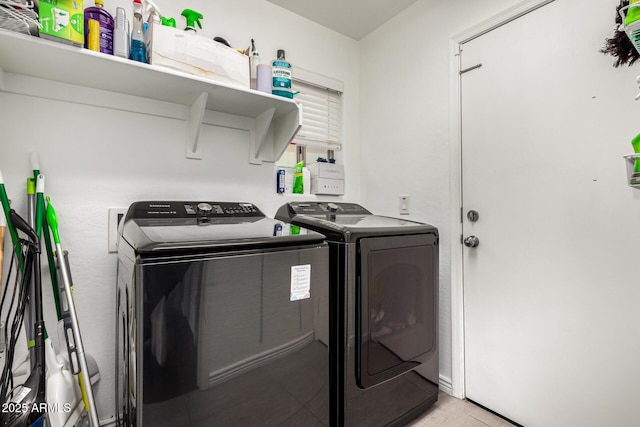 laundry room with light tile patterned floors, laundry area, and washing machine and dryer