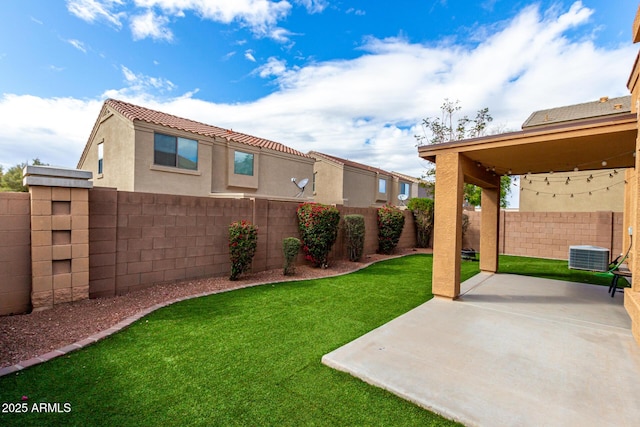 view of yard featuring central AC unit, a patio area, and a fenced backyard