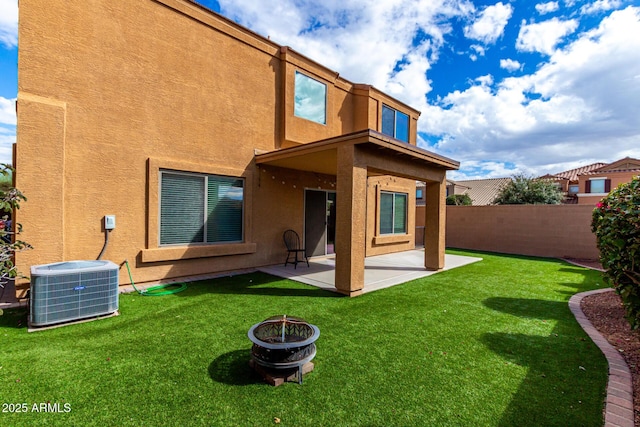 rear view of property featuring cooling unit, fence, a patio area, and stucco siding