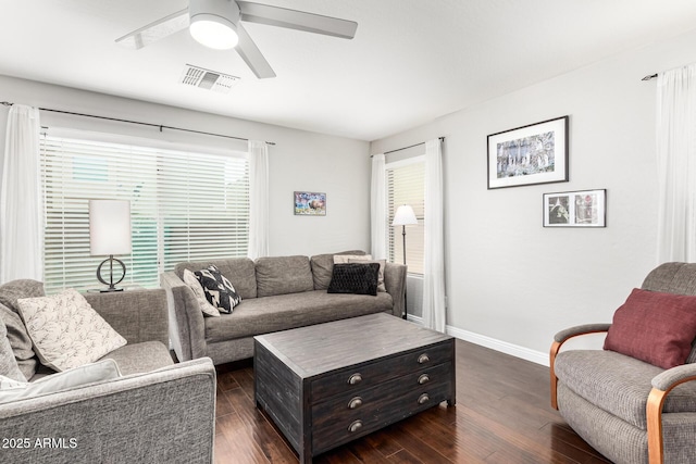 living area featuring dark wood-style floors, visible vents, plenty of natural light, and ceiling fan