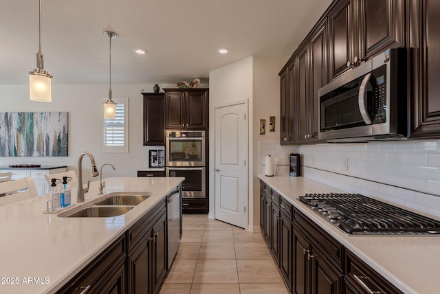 kitchen featuring backsplash, light countertops, a sink, and stainless steel appliances