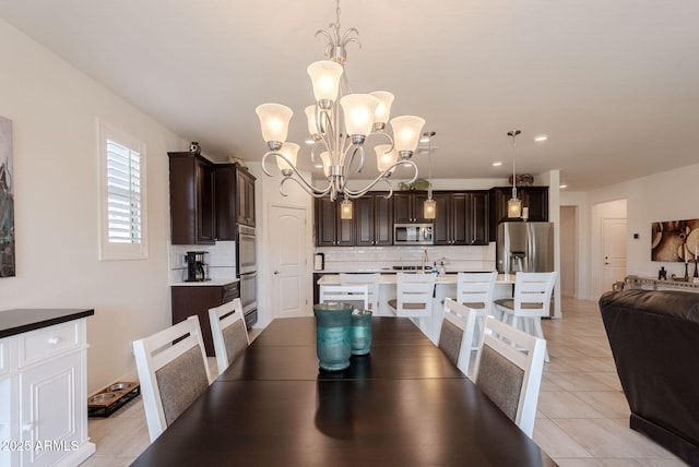 dining area with light tile patterned flooring and a notable chandelier