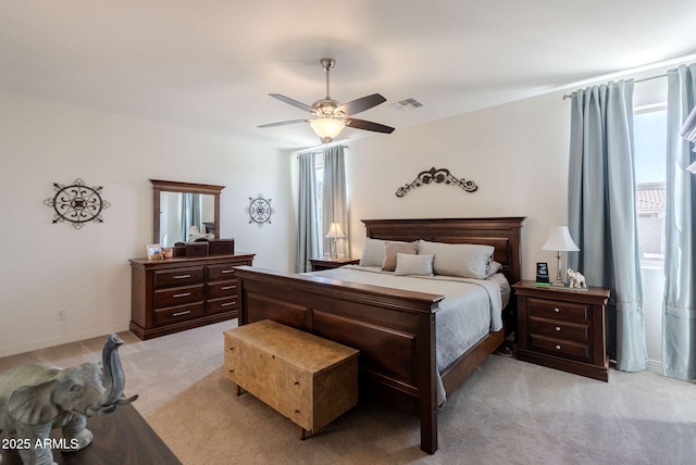 bedroom featuring light carpet, baseboards, visible vents, and ceiling fan