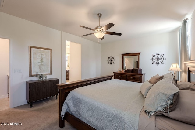 bedroom featuring ceiling fan, connected bathroom, and light colored carpet