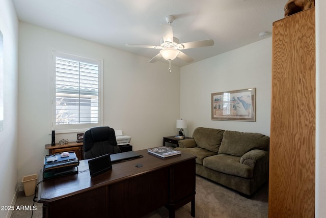 carpeted office space featuring ceiling fan