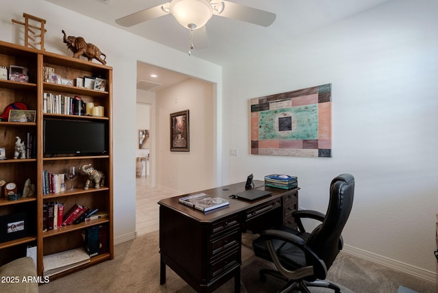 office space with a ceiling fan, carpet, and baseboards