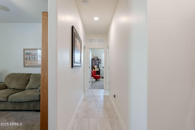 corridor featuring baseboards, visible vents, recessed lighting, and light tile patterned floors