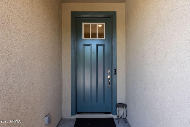 property entrance with stucco siding