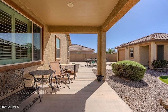 view of patio / terrace with outdoor dining space and fence