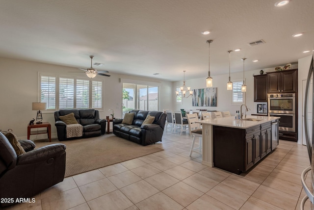 living area featuring a healthy amount of sunlight, visible vents, recessed lighting, and light tile patterned floors