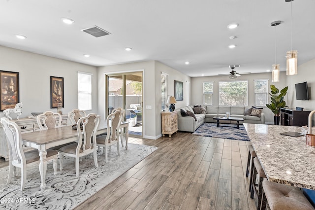 dining room with ceiling fan and light wood-type flooring