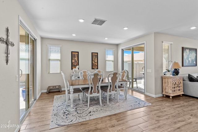 dining area with light wood-type flooring and plenty of natural light