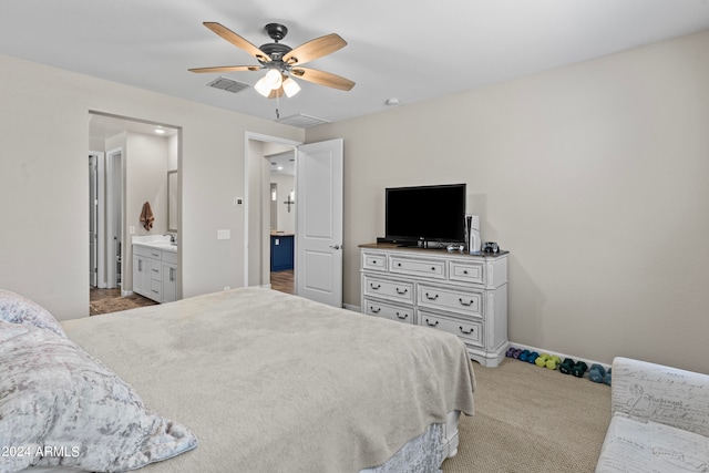 carpeted bedroom featuring connected bathroom and ceiling fan