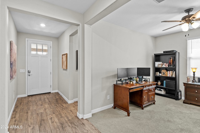 office area with light wood-type flooring and ceiling fan