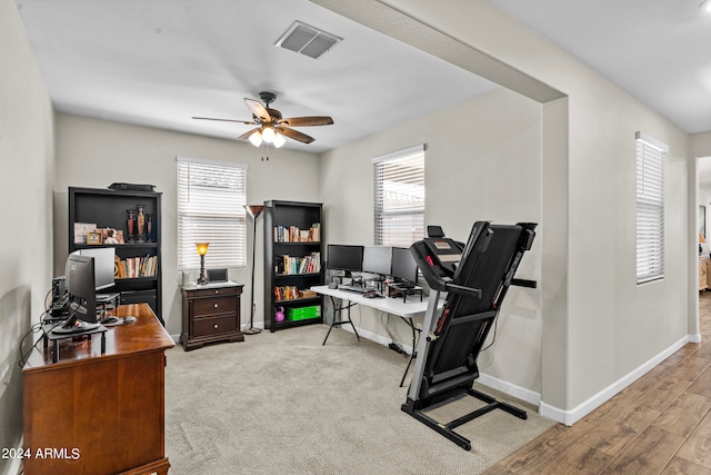 home office featuring ceiling fan and light hardwood / wood-style floors