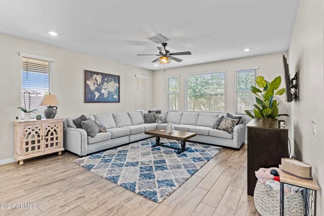 living room featuring ceiling fan and light hardwood / wood-style flooring