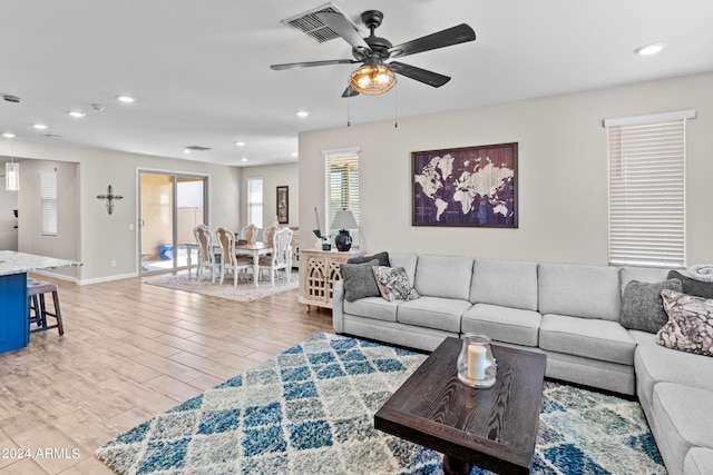 living room with ceiling fan and wood-type flooring