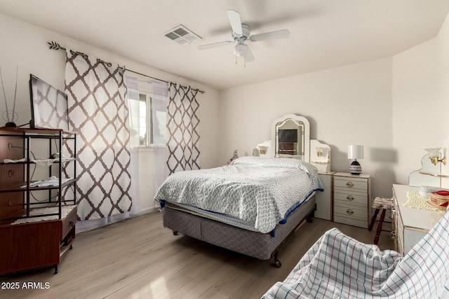 bedroom with light hardwood / wood-style floors and ceiling fan