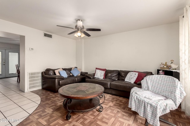 living room featuring parquet flooring, ceiling fan, and french doors