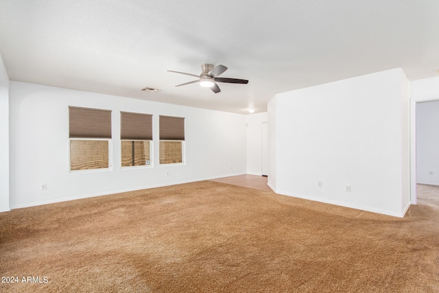 spare room featuring ceiling fan and carpet floors