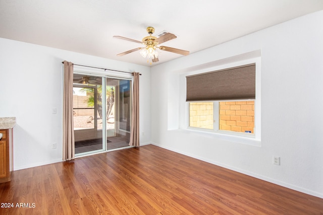 empty room featuring ceiling fan and hardwood / wood-style flooring