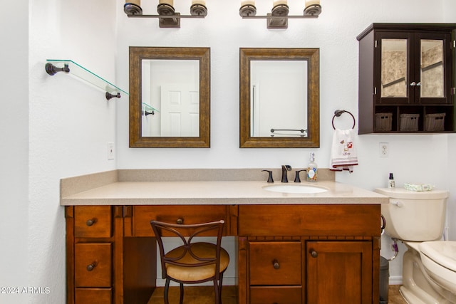 bathroom featuring toilet and vanity