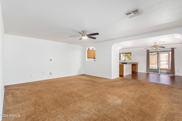 carpeted empty room featuring ceiling fan