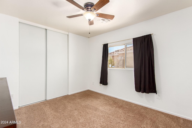 spare room with ceiling fan and carpet floors