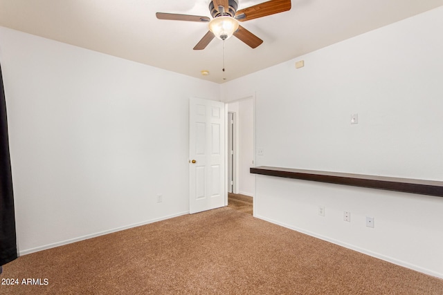 unfurnished room featuring ceiling fan and carpet floors