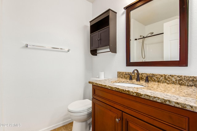 bathroom with vanity, toilet, and walk in shower