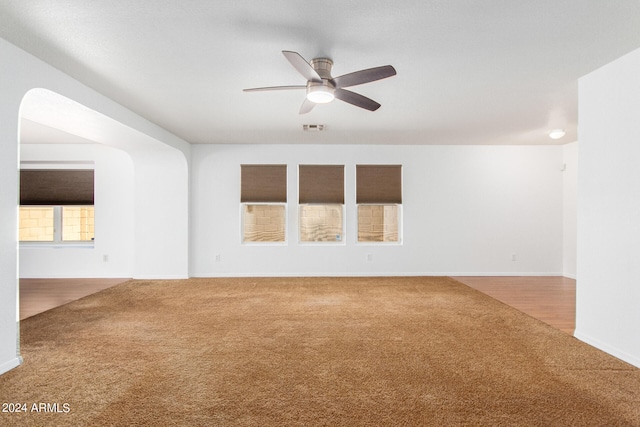 unfurnished living room with hardwood / wood-style flooring and ceiling fan