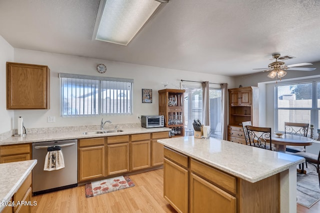 kitchen with ceiling fan, plenty of natural light, stainless steel dishwasher, and sink