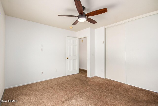 unfurnished bedroom featuring a closet, ceiling fan, and carpet floors