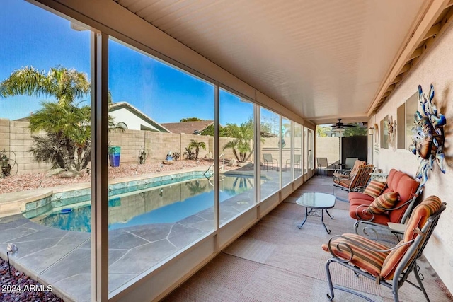 sunroom featuring ceiling fan