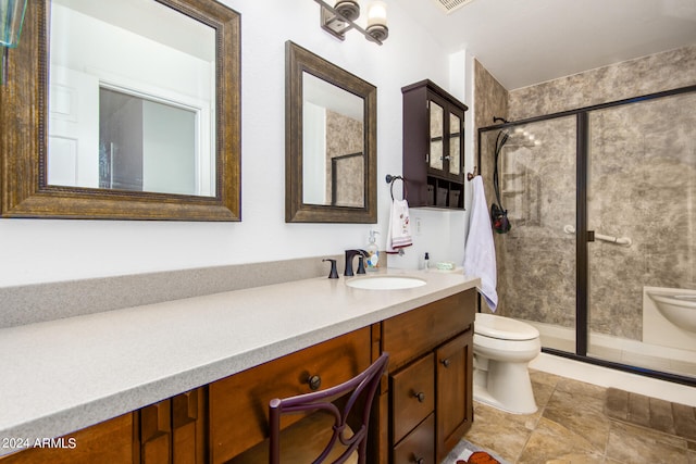 bathroom featuring vanity, toilet, and an enclosed shower