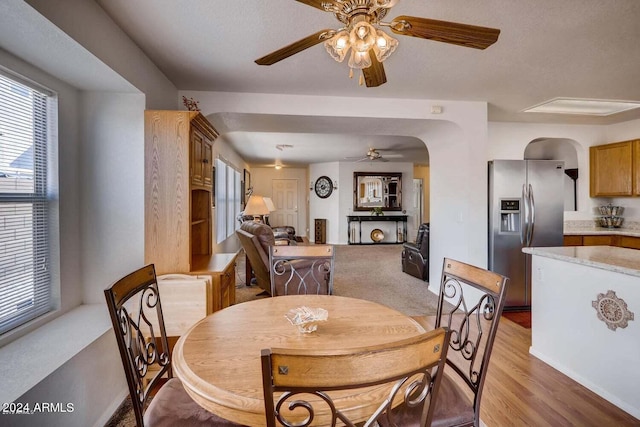 dining space featuring light wood-type flooring and ceiling fan