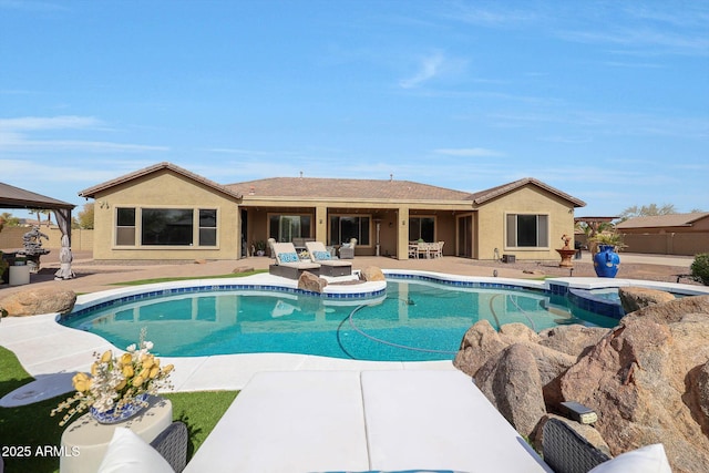 view of swimming pool featuring a patio area, outdoor lounge area, and a pool with connected hot tub